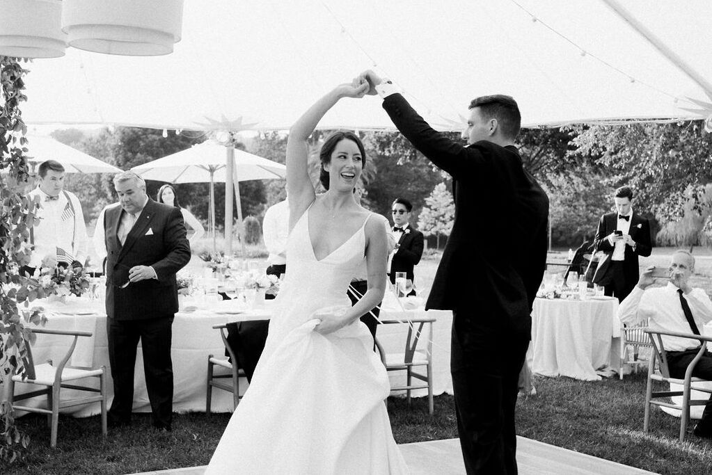 4th of July Wedding: A groom twirling a bride at their wedding reception.