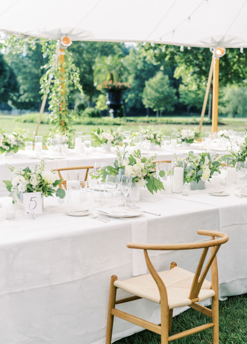 4th of July Wedding: Classic white and green reception table decor with wooden chairs in a tented area.