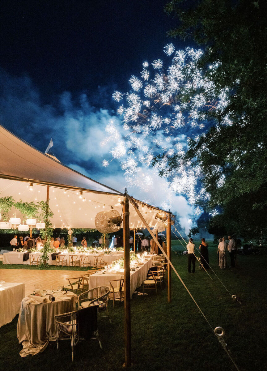4th of July Wedding: Fireworks bursting over a tented wedding reception.