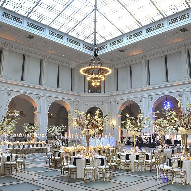 Ballroom wedding: Gorgeous ballroom wedding reception at the Brooklyn Museum with an opaque glass ceiling featuring a glowing chandelier and golden tables