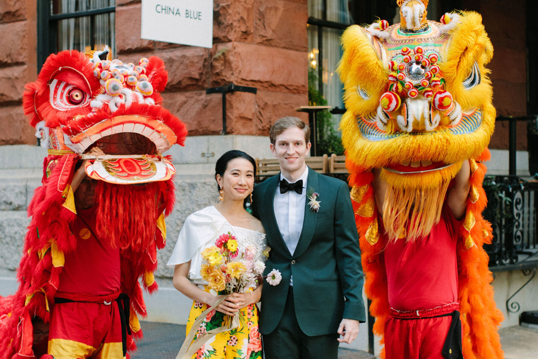Wedding Traditions: A bride and groom with a gold and red lion at their wedding ceremony.