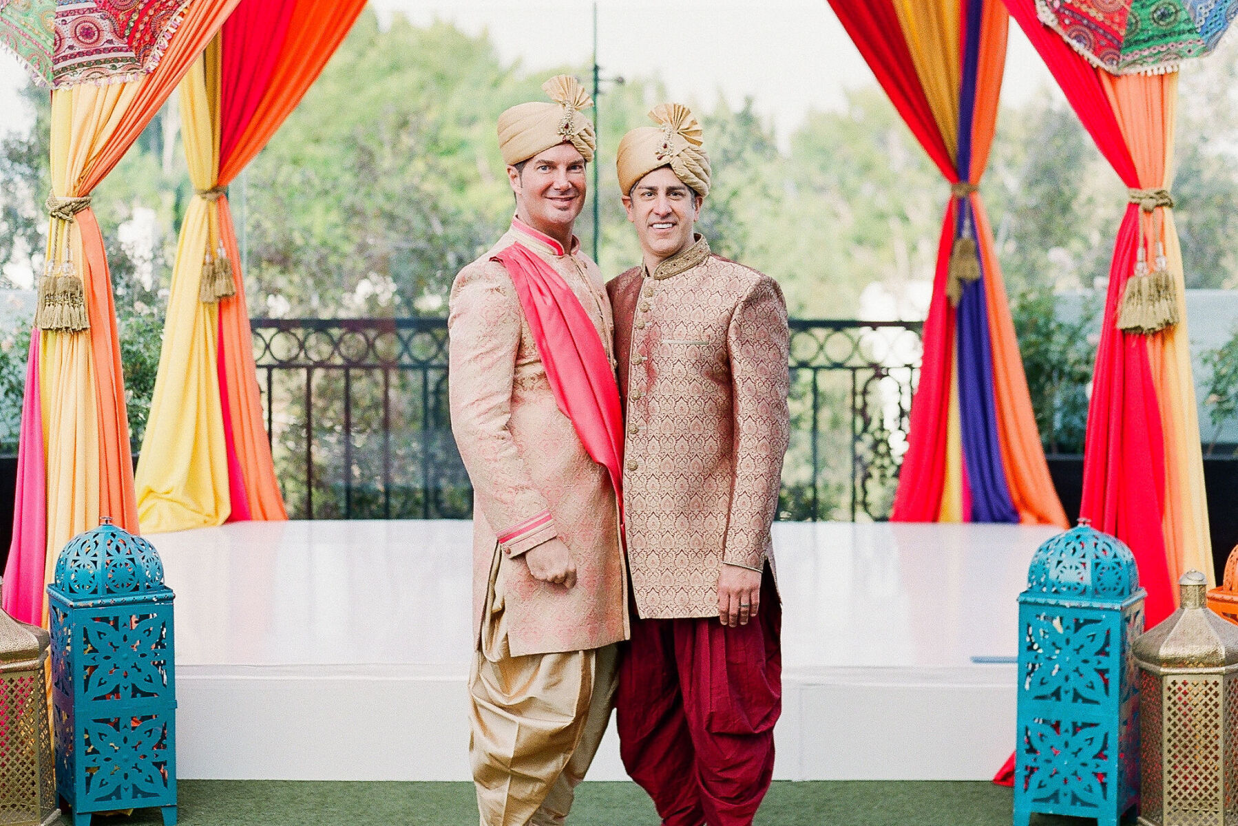 Wedding Traditions: Two grooms wearing traditional Indian attire.