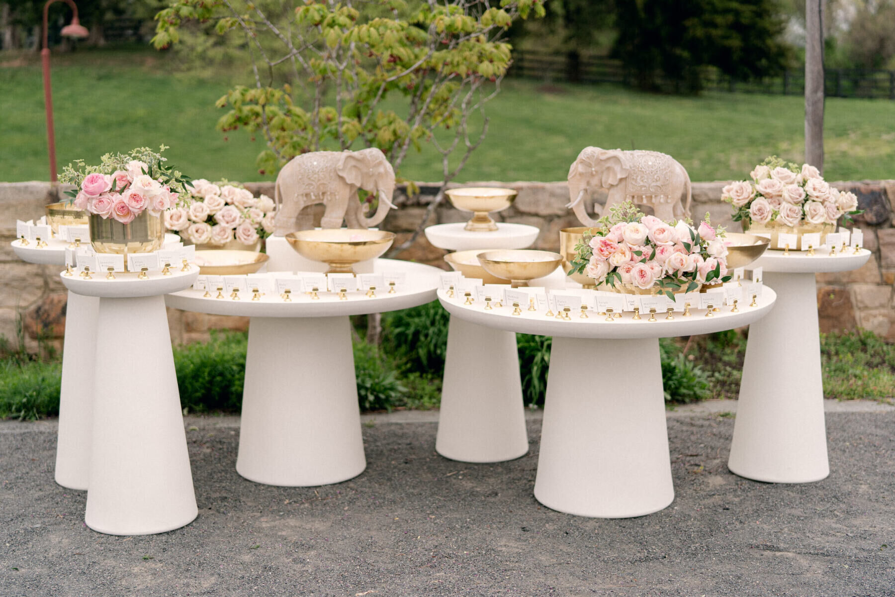 Wedding Traditions: Blush, green, and gold tones and elephants decorating the place card table.