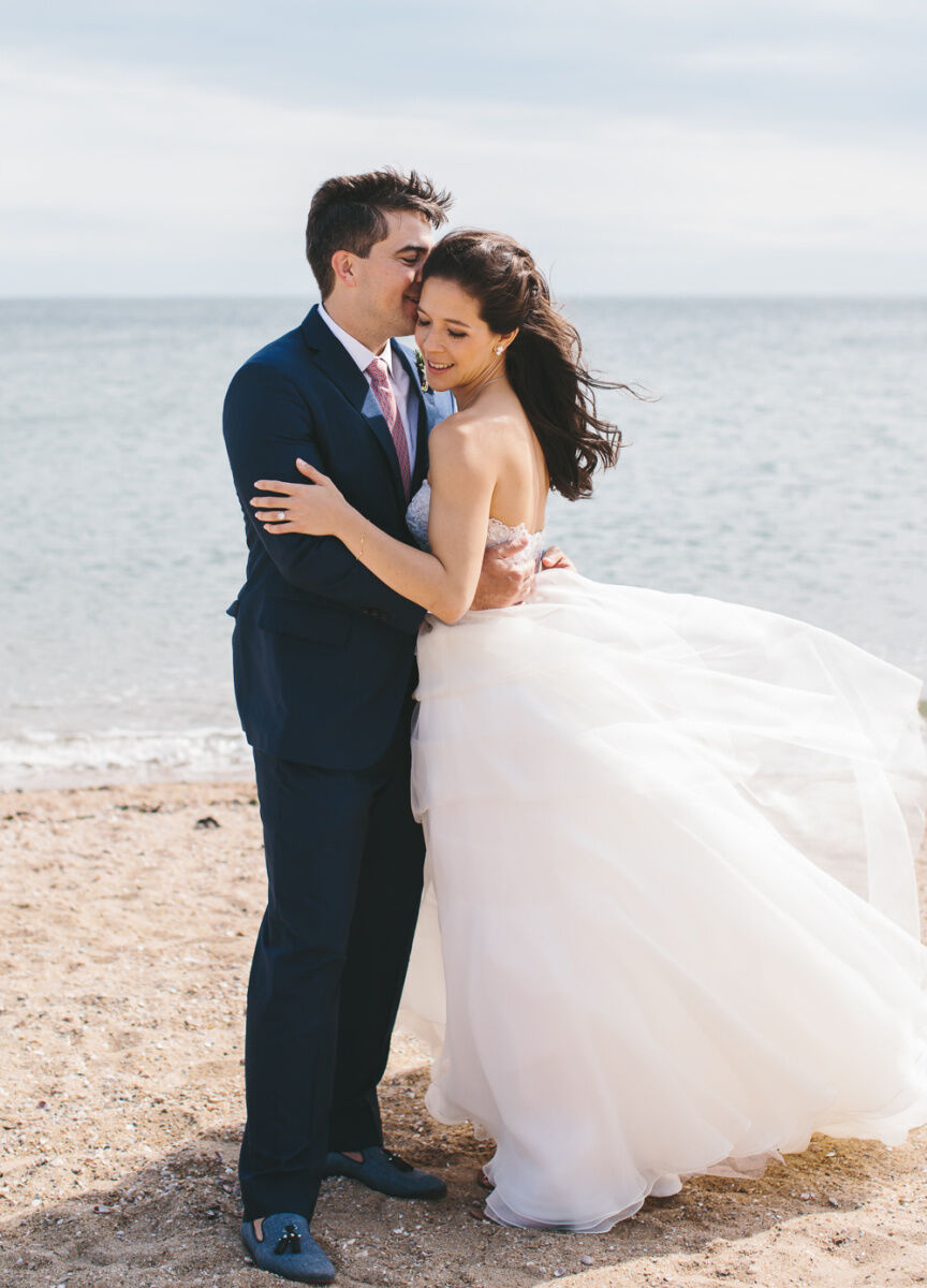 Wedding Traditions: A bride and groom embracing on the beach.