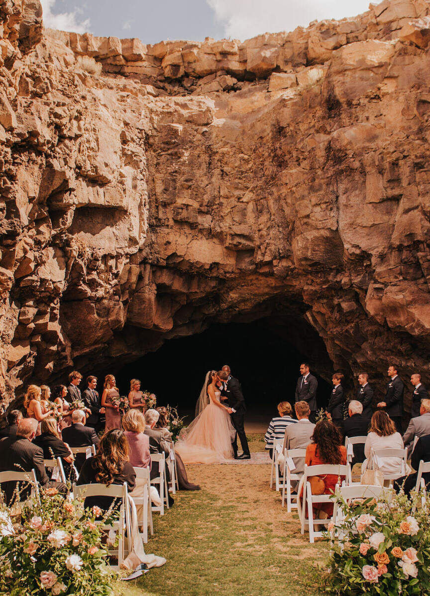 Adventurous Wedding Venues: A bride and groom kissing at their wedding ceremony at Pronghorn Resort.
