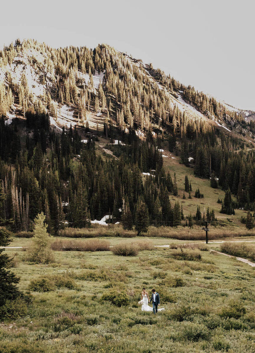 Adventurous Wedding Venues: A couple walking outdoors for their wedding at Snowpine Lodge.