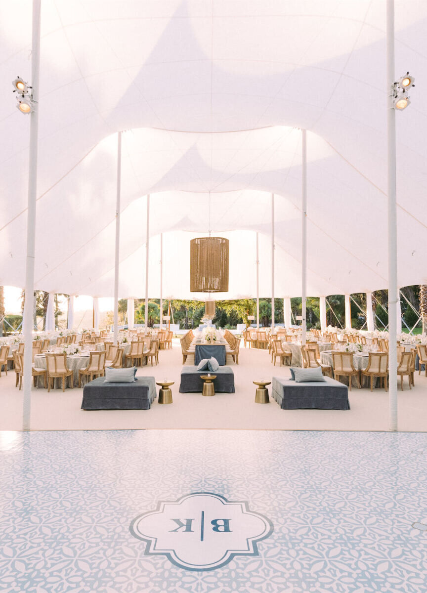 An at-home wedding reception set in a sailcloth tent featured a patterned dancefloor and the couple's monogram.