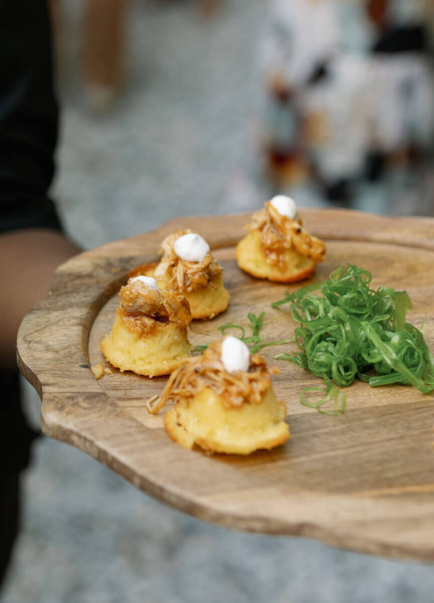 Passed appetizers were served on wood platters at an authentic modern wedding reception.