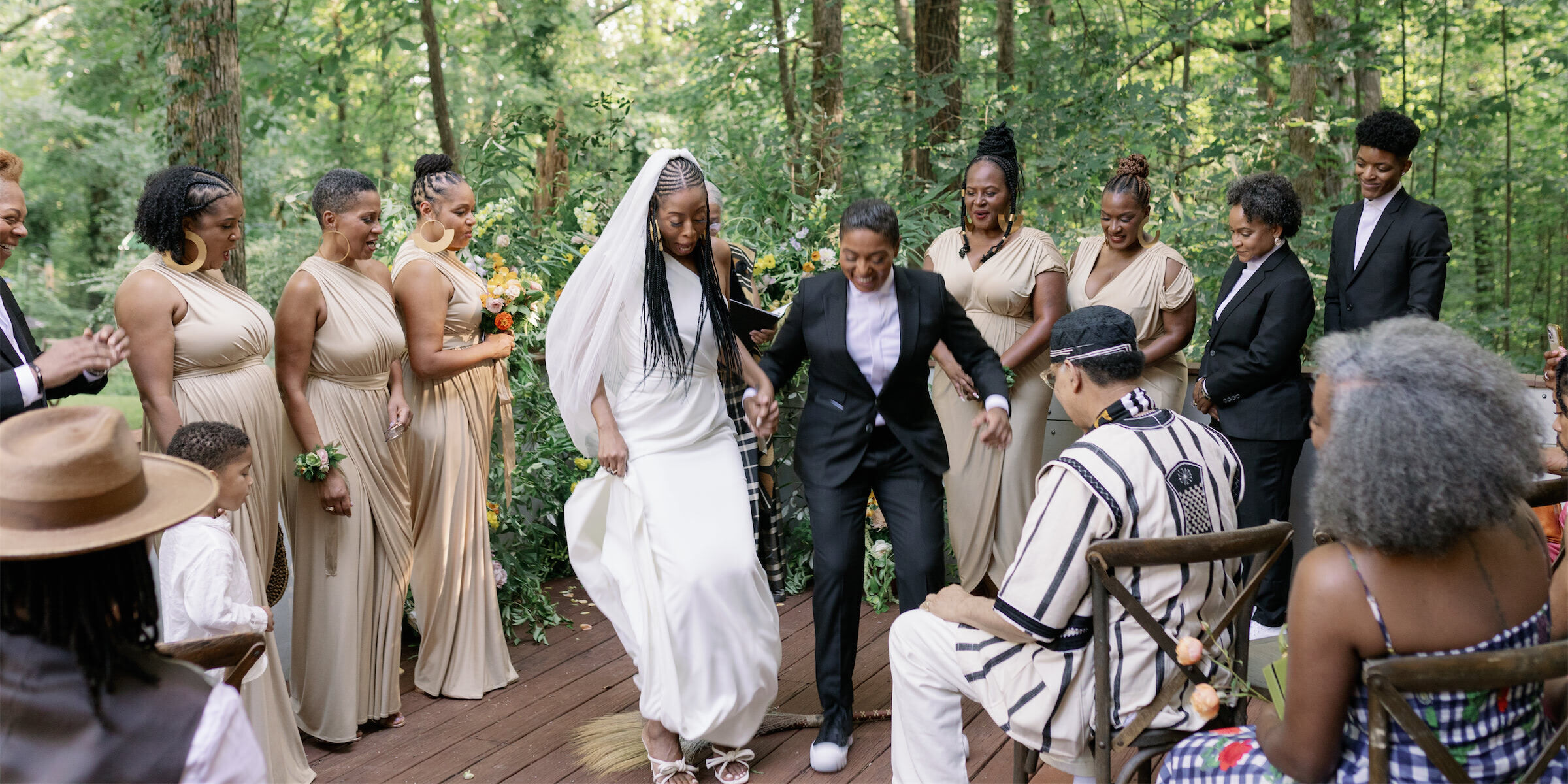 A happy couple jumps the broom at the end of their authentic modern wedding ceremony in Atlanta.