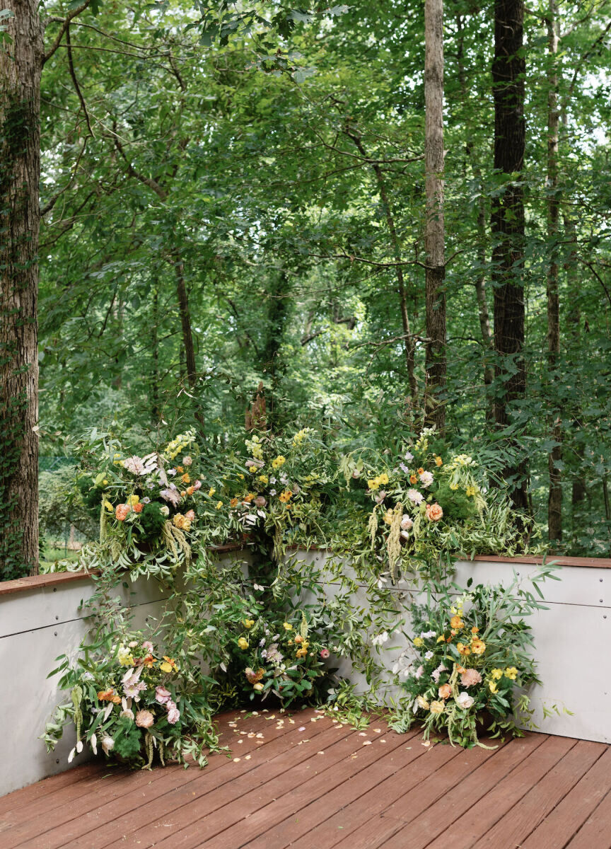A floral installation was the centerpiece of an authentic modern wedding ceremony in the backyard of a private home in Georgia.