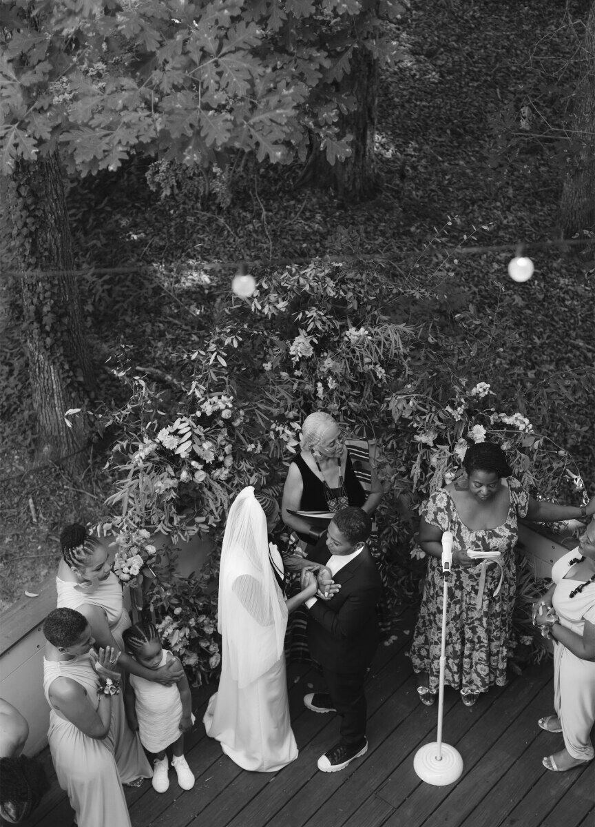 An overhead photo of two brides getting married during their authentic modern wedding ceremony.