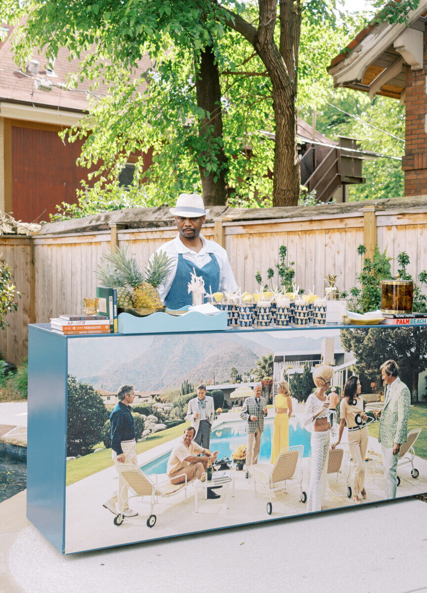 A custom bar at a backyard wedding channels Slim Arons and poolside vacations.