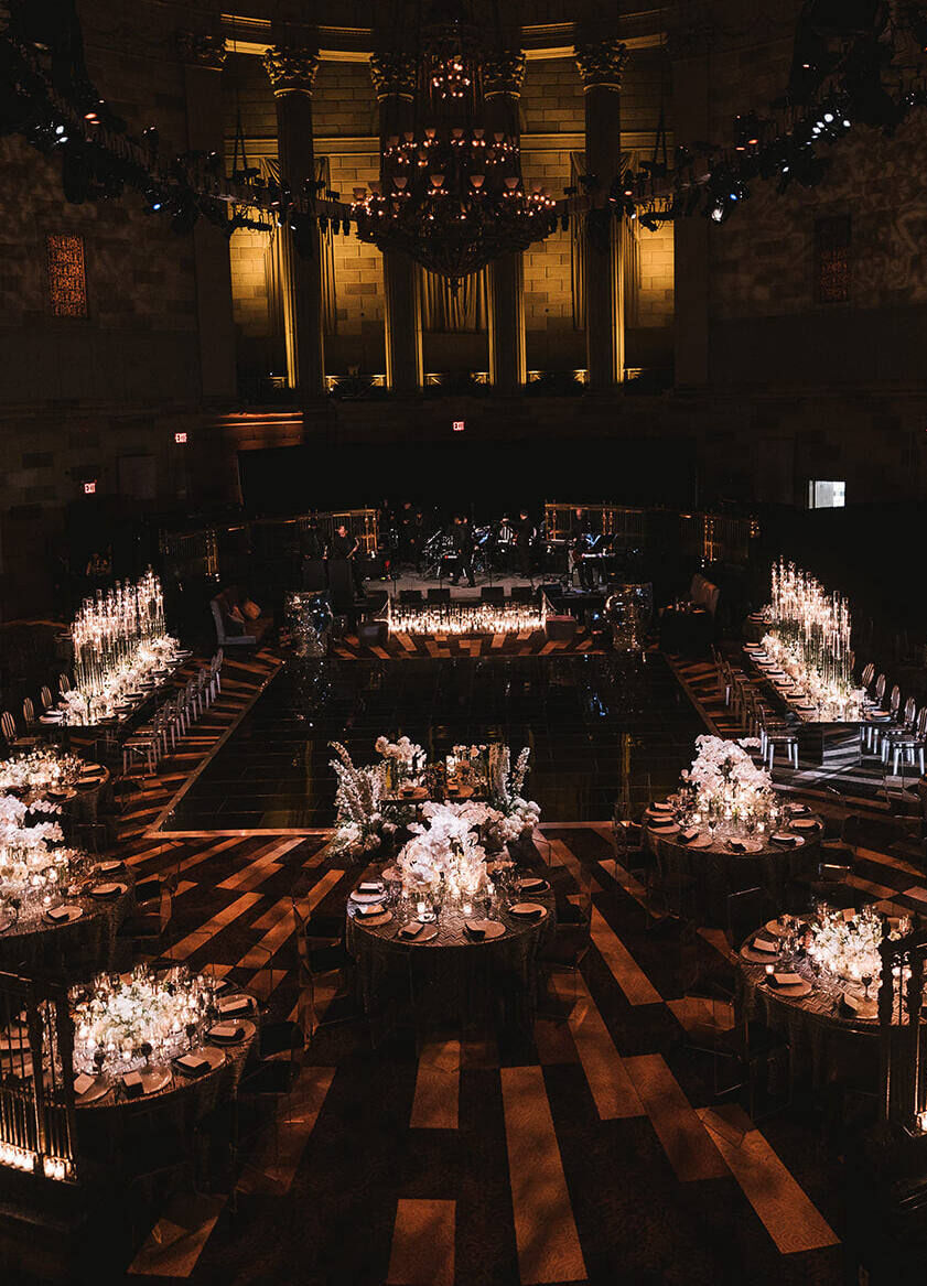 Ballroom wedding details: A mix of reception tables decorated with candlelight and white flowers were just two of the glam ballroom wedding details at this New York City wedding.