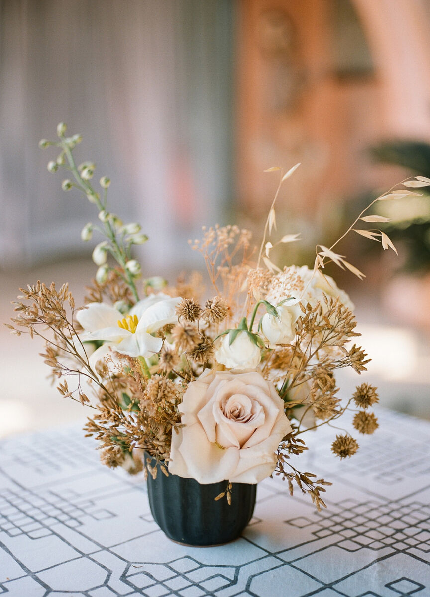 Neutral pink wedding reception centerpiece flowers at this bohemian wedding in Mexico.