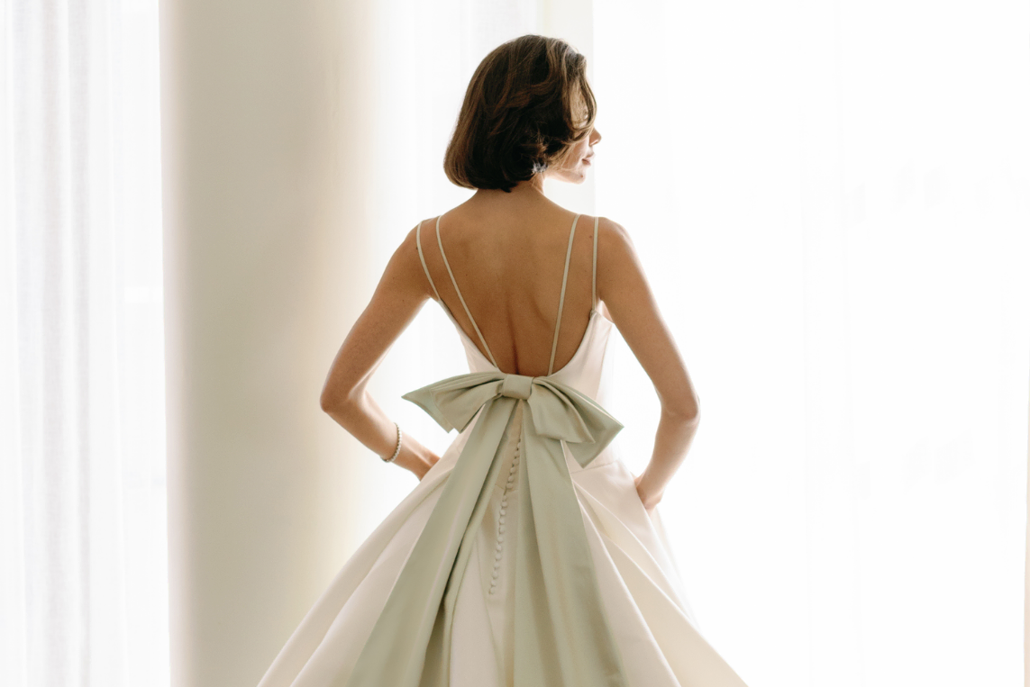 Bridal Fashion Week: The back of a Mark Ingram dress with a pistachio-hued bow.