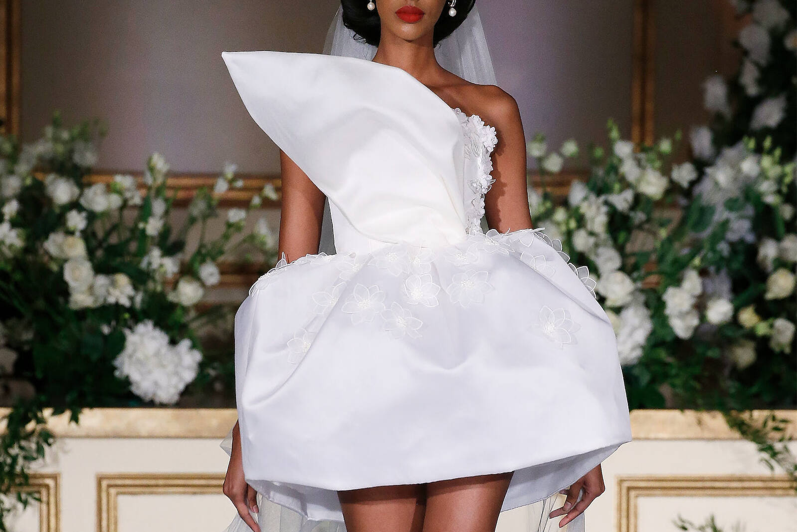 Bridal Fashion Week: A bride walking down the runway in a mini dress from Nardos.