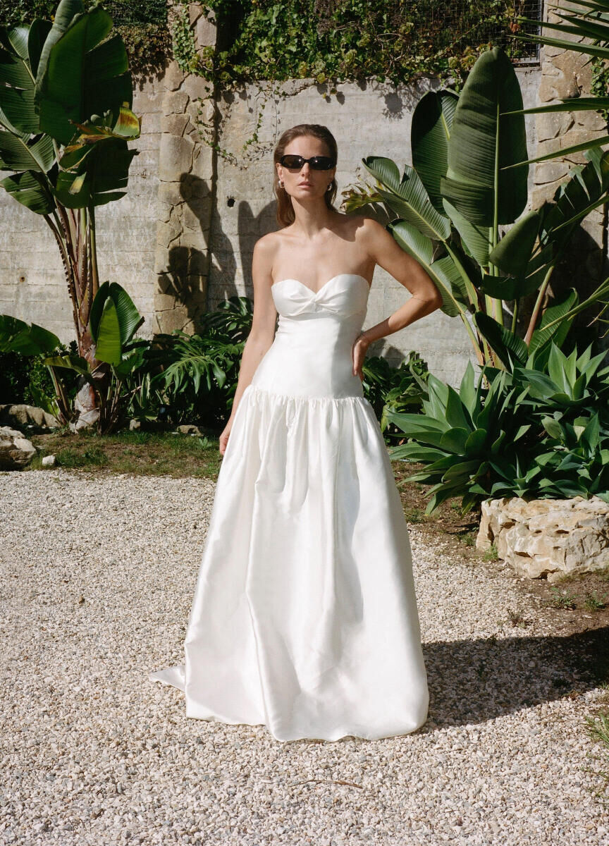 Bridal Fashion Week: A bride in a drop waist wedding gown by The OWN Studio.