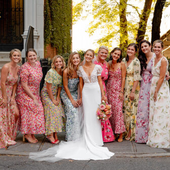Bride with bridesmaids in mismatched floral bridesmaid dresses 