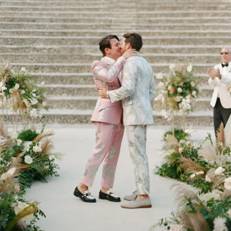 Wedding couple kissing in the circle of their floral ceremony alter circle