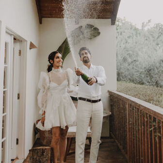 Wedding couple kissing in the circle of their floral ceremony alter circle