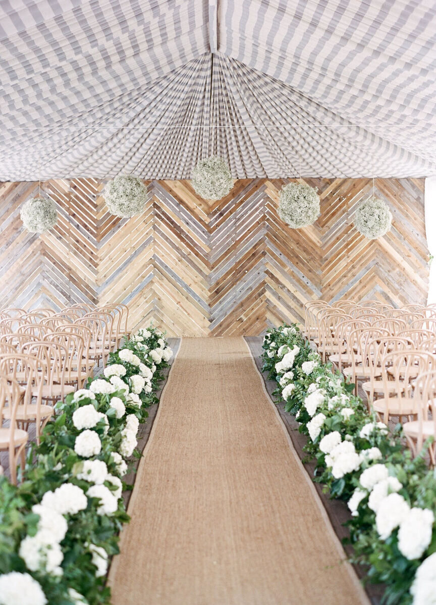 Ceiling Wedding Decor: An indoor ceremony space with striped drapery overhead.