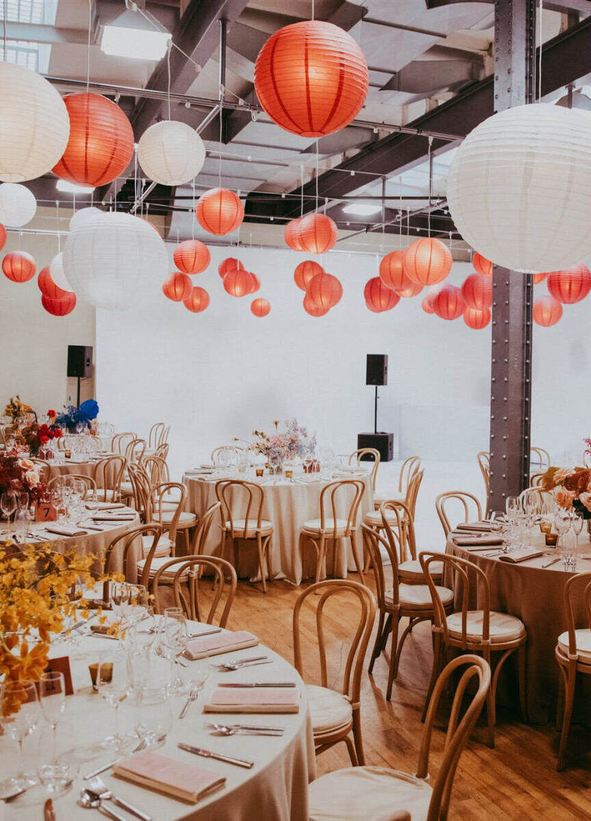 Ceiling Wedding Decor: Red and white lanterns hanging from the ceiling at an indoor reception area.