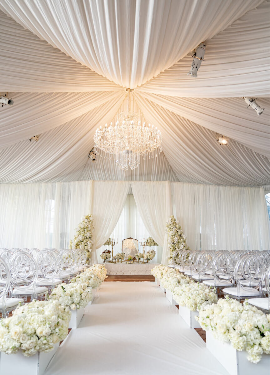 Ceiling Wedding Decor: White fabric drapery converging at one chandelier at a wedding ceremony in San Francisco.