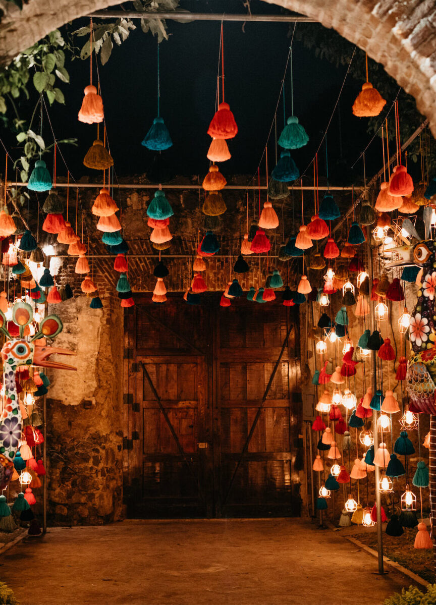 Ceiling Wedding Decor: Hanging tassels at the entrance to a late-night reception area in Guatemala.