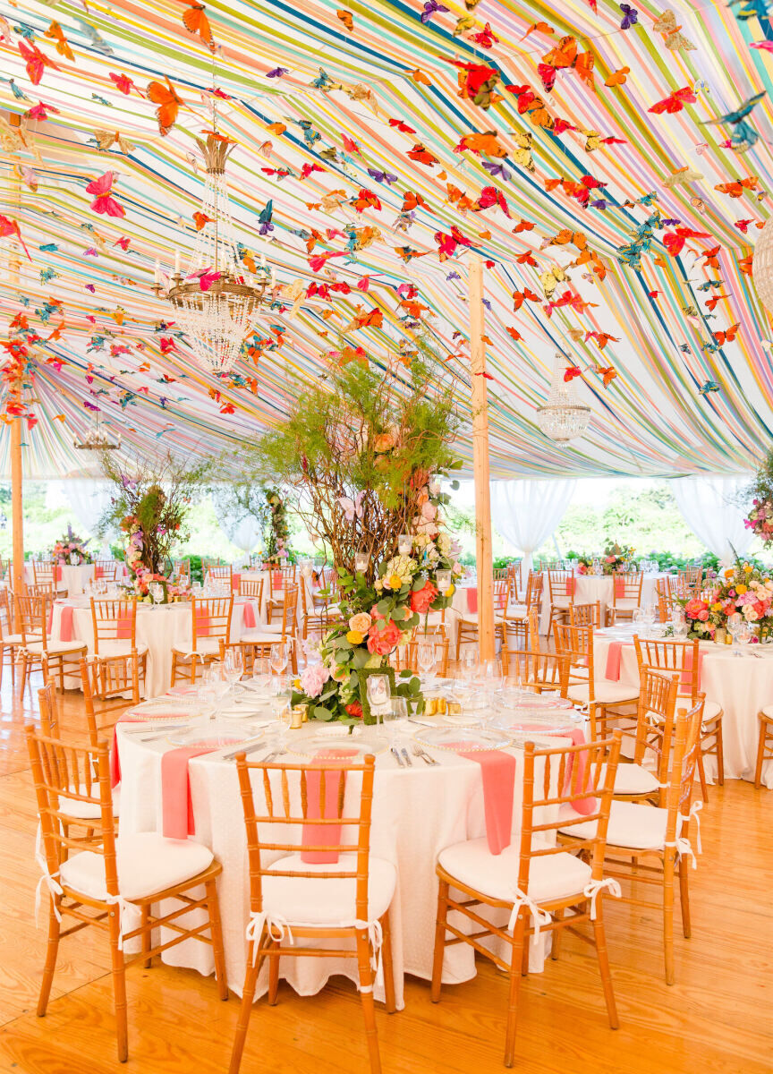Ceiling Wedding Decor: Decorative butterflies covering the ceiling a rainbow-striped tent.