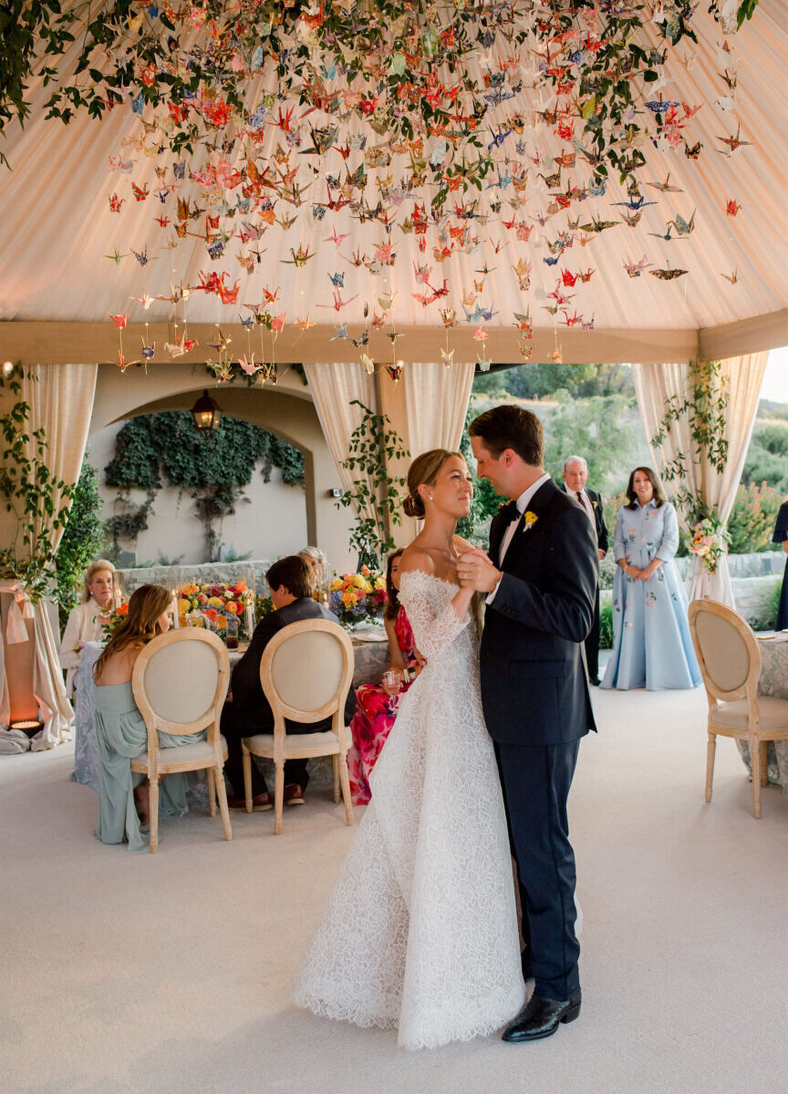 Ceiling Wedding Decor: Paper cranes functioning as an installation at a tented wedding reception.