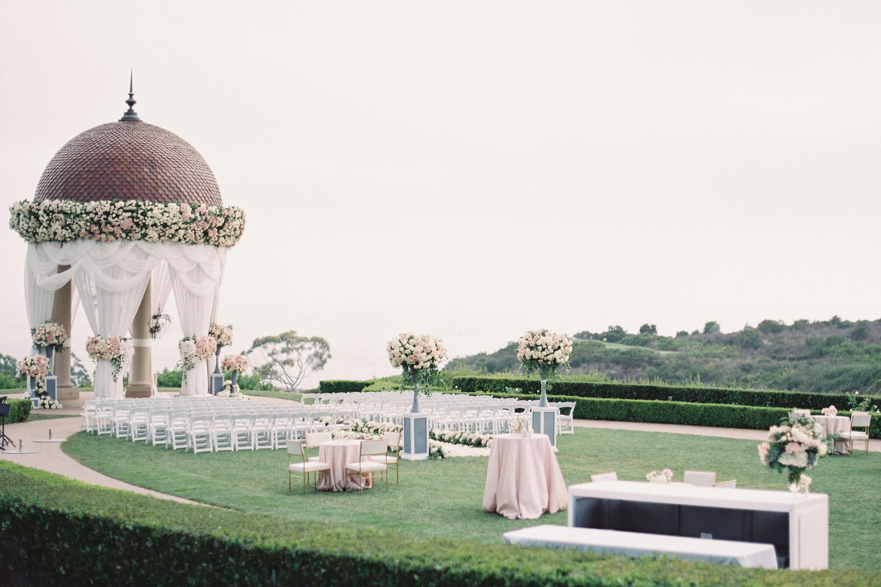 Celebrity Wedding: An outdoor ceremony with a tiled gazebo and golf course in the background in Newport Beach.