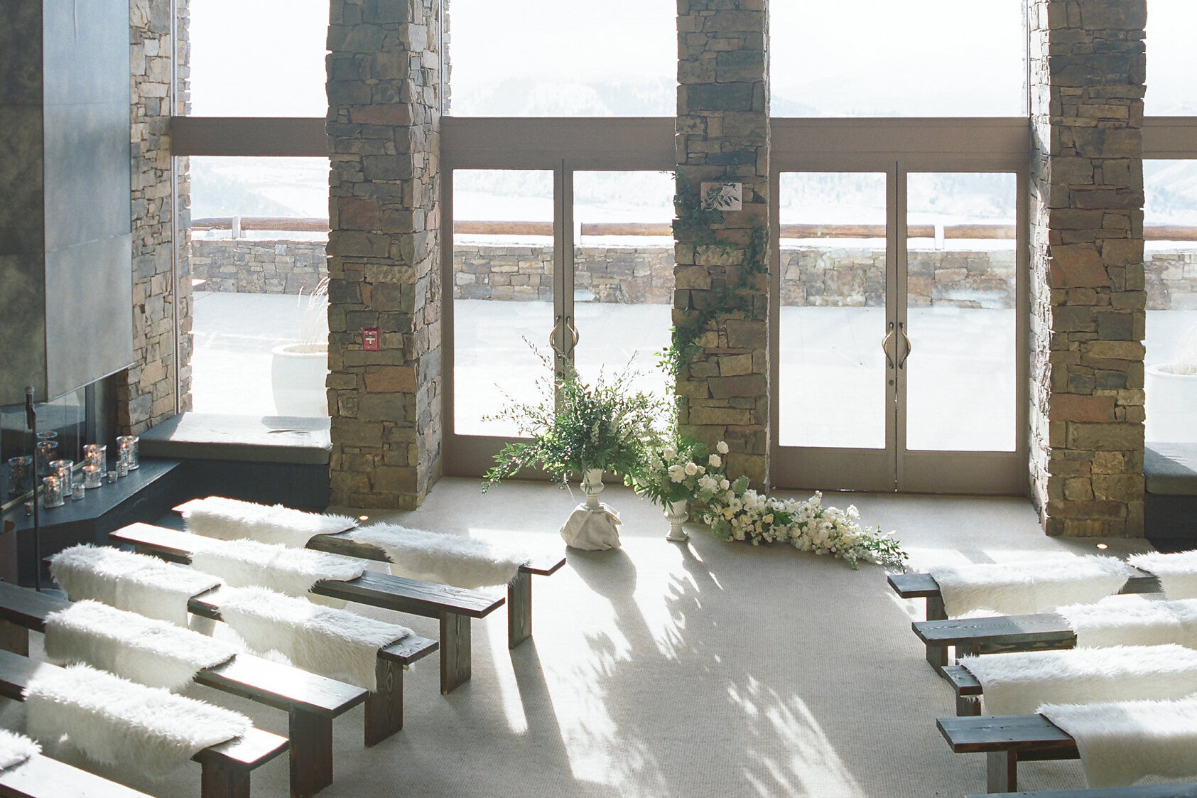 Celebrity Wedding: A ceremony set up looking out the floor to ceiling windows of Amangani in the mountains of Jackson, Wyoming.