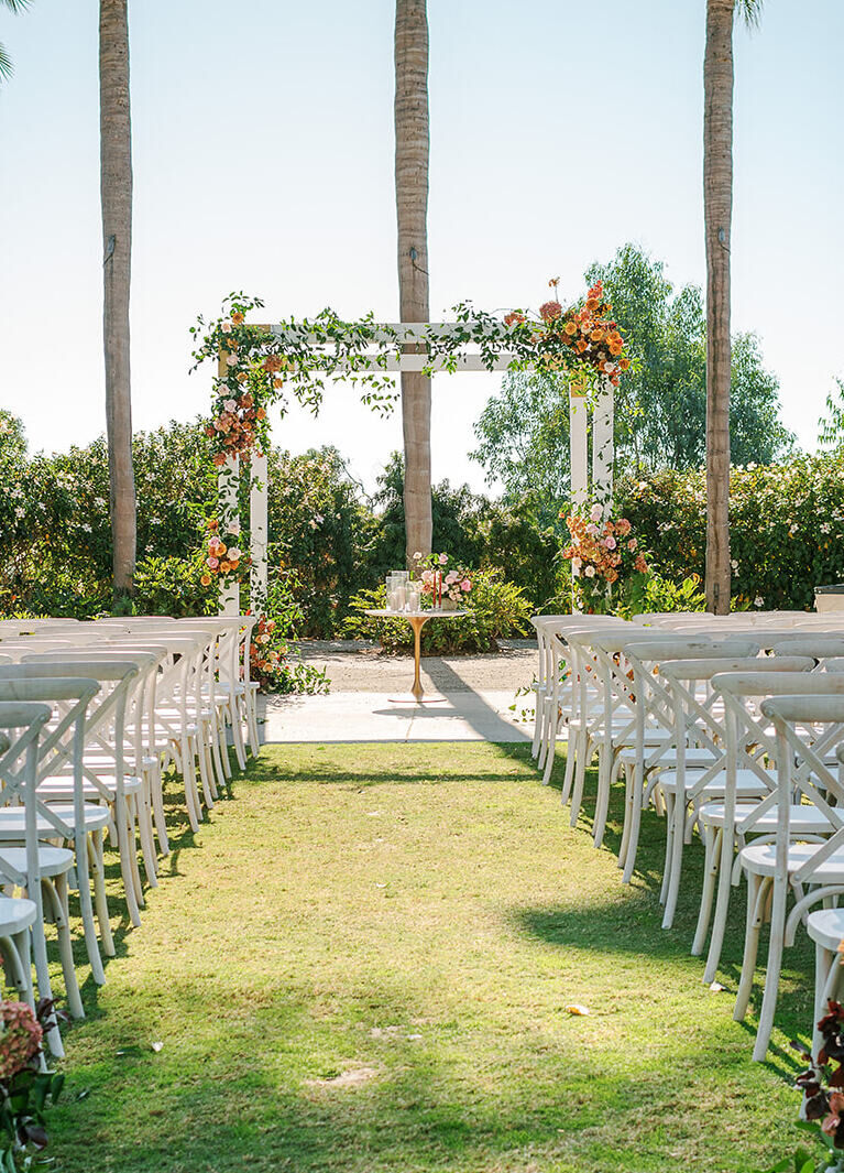 City Weddings: A ceremony display with white chairs and a white, floral-accented gazebo in Carlsbad, California.