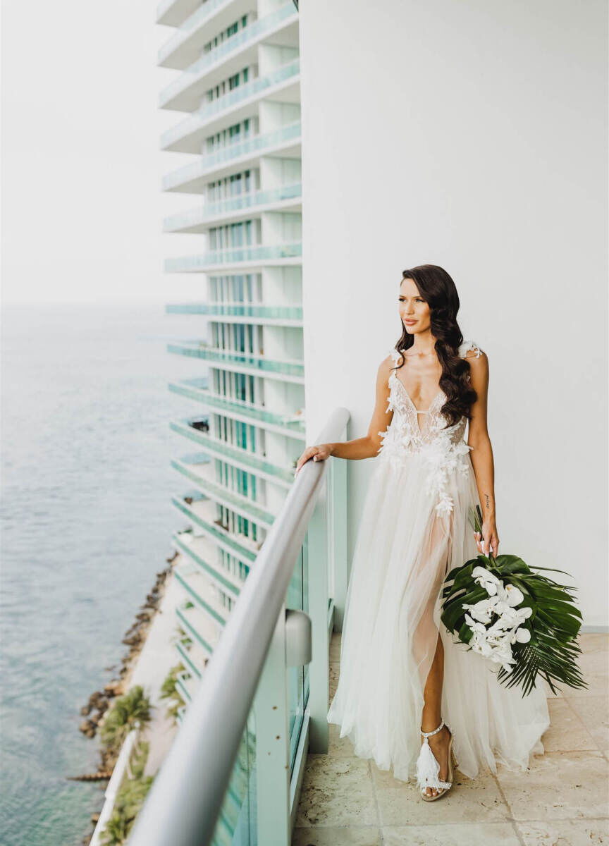 City Weddings: A bride looks out on a hotel balcony on her wedding day in Miami.
