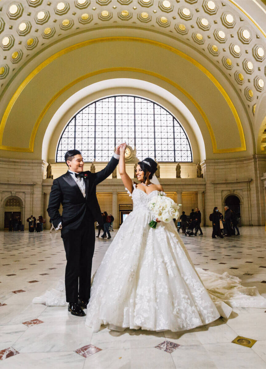 City Weddings: A groom twirling a bride in Washington Union Station.