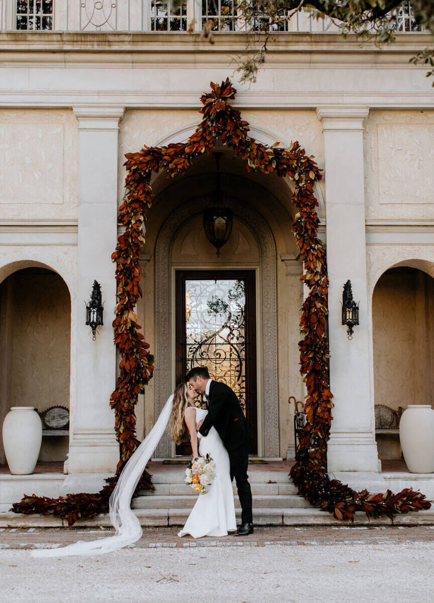 City Weddings: A wedding couple sharing a kiss outside the Commodore Perry Estate in Austin.