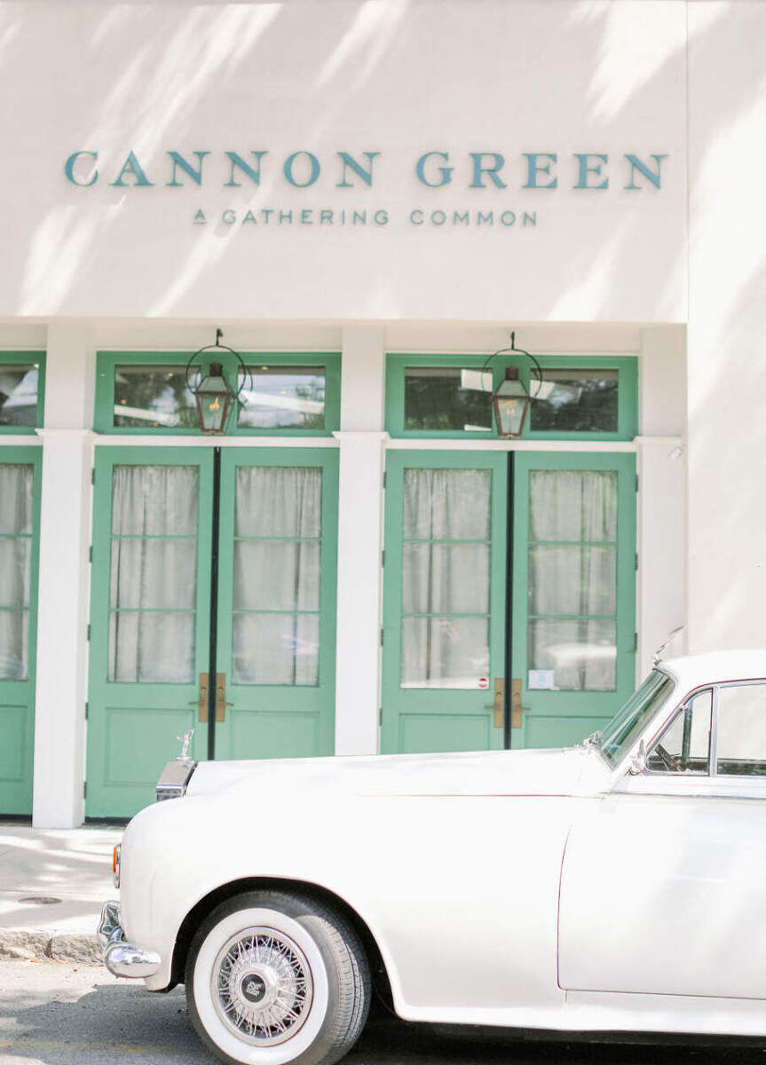 City Weddings: An old fashioned car parked in front of Cannon Green, a wedding venue with seafoam green shutters in Charleston.