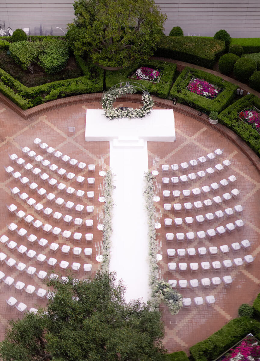 City Weddings: A bird's-eye view of an outdoor wedding ceremony with a white aisle and chairs in a courtyard at The Ritz-Carlton in San Francisco.