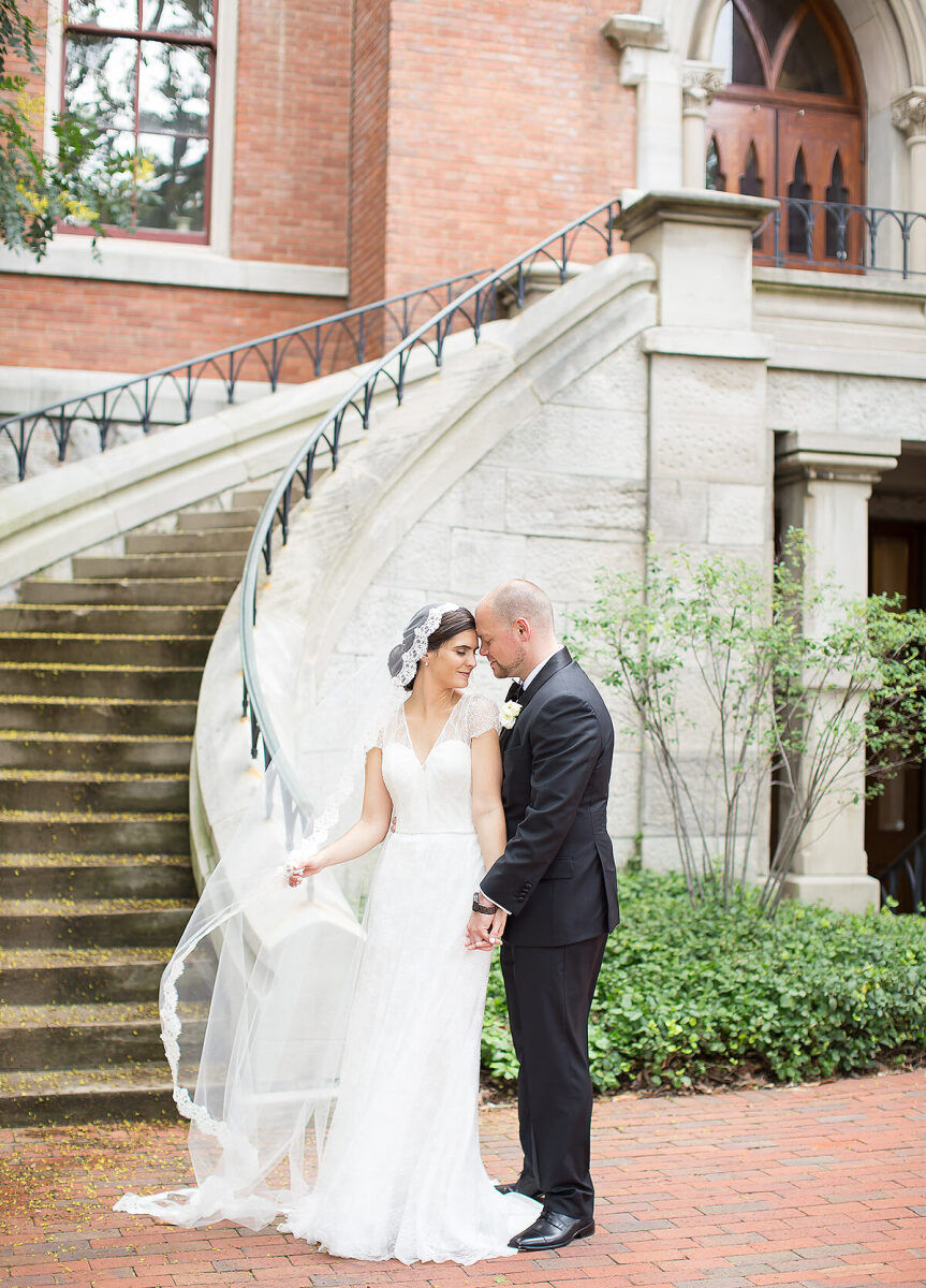 City Weddings: A wedding couple looking at each other at the bottom of an outdoor staircase in Nashville.