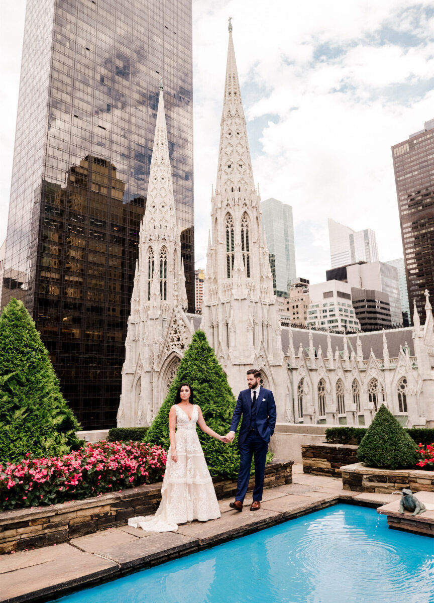 City Weddings: A wedding couple holding hands at a garden rooftop venue overlooking Manhattan.