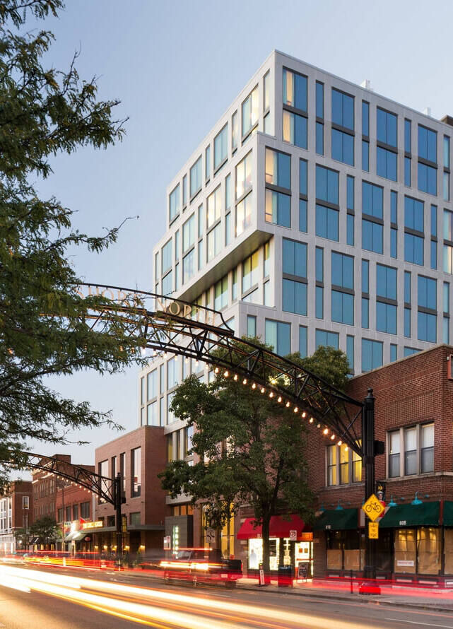 City Weddings: A modern hotel with an iron arch in the foreground and brick building nearby.