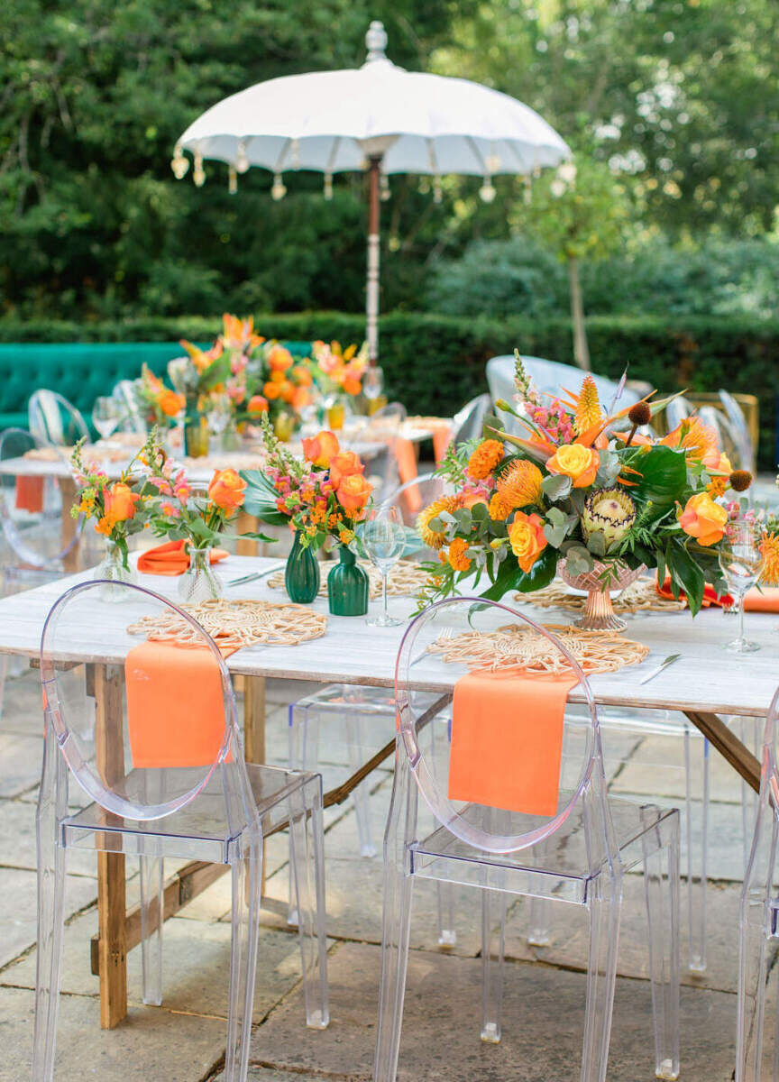 Guests first gathered during a colorful countryside wedding weekend, at an orange luncheon honoring the bride's Zimbabwean roots.