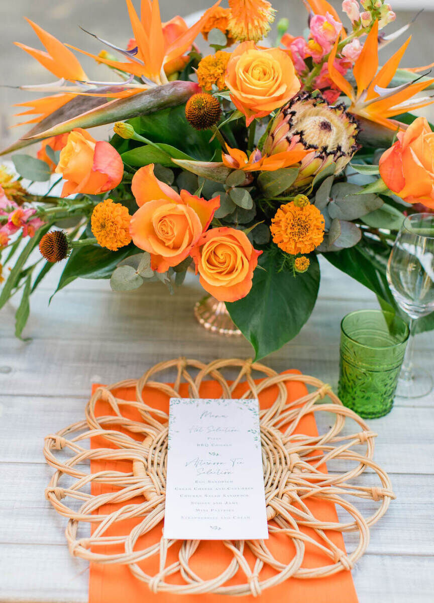 Birds of paradise flowers were a main inspiration for an orange-hued luncheon at a colorful countryside wedding weekend.