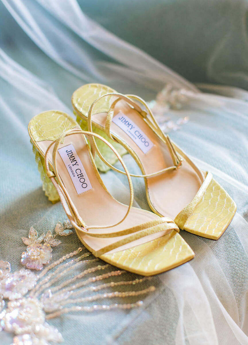Yellow Jimmy Choo sandals matched the bride's yellow lehenga during her colorful countryside wedding.