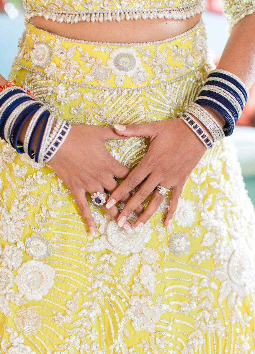 The bride's yello Manish Malhotra lehenga was paired with sapphire blue jewelry at her colorful countryside wedding.