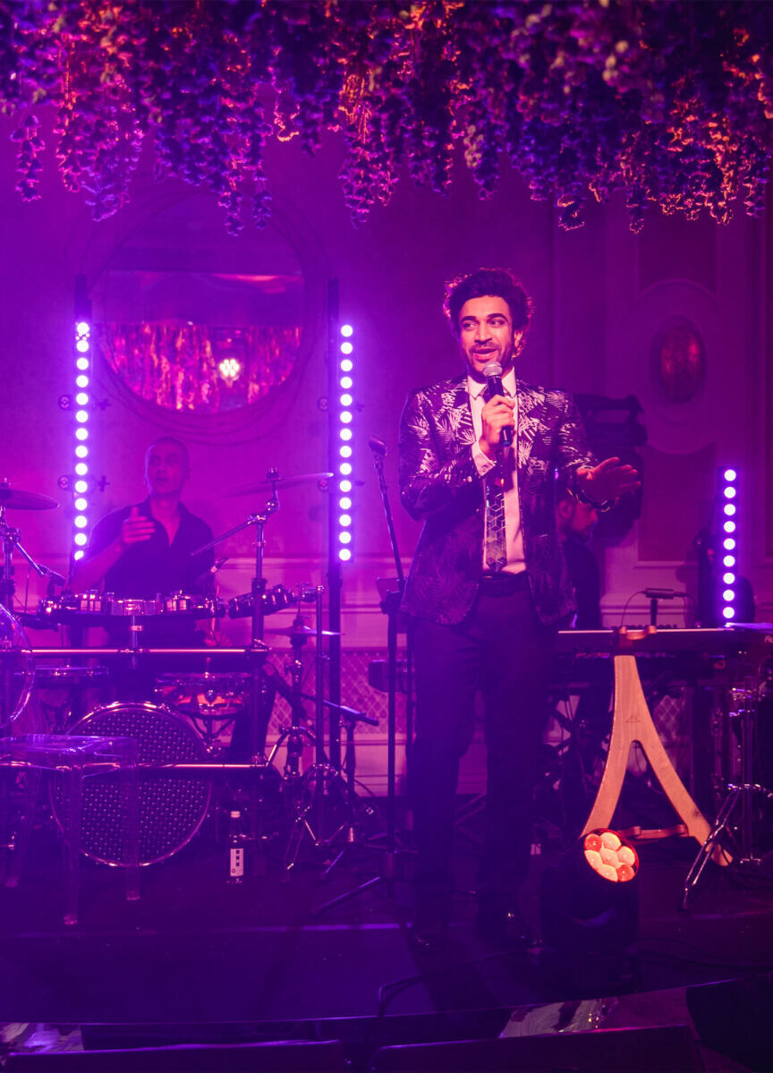 Navin Kundra performs during a colorful countryside wedding reception inside the Four Seasons Hampshire.