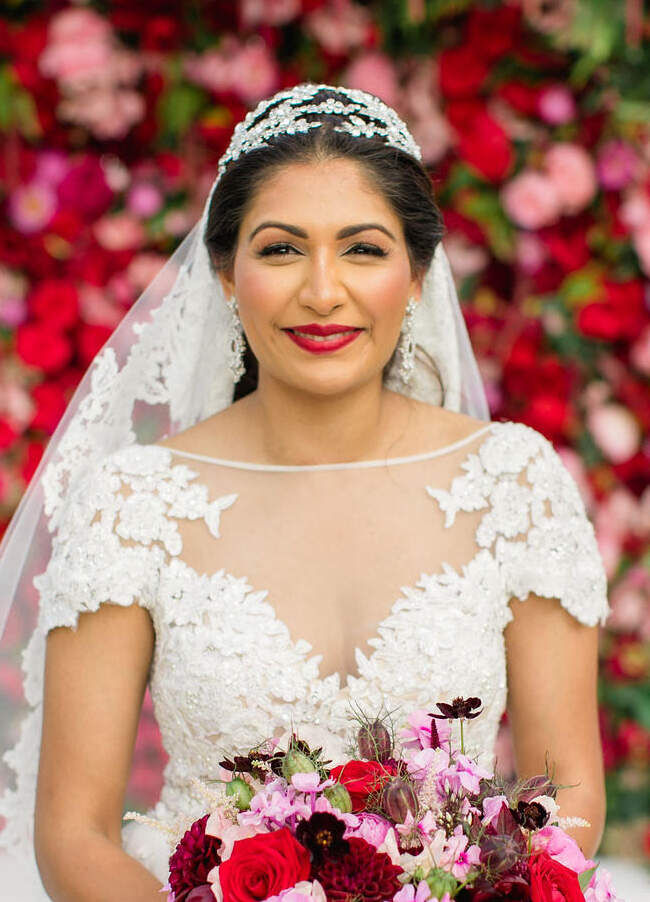 A bride wore one of her signature red lipsticks at her colorful countryside wedding.