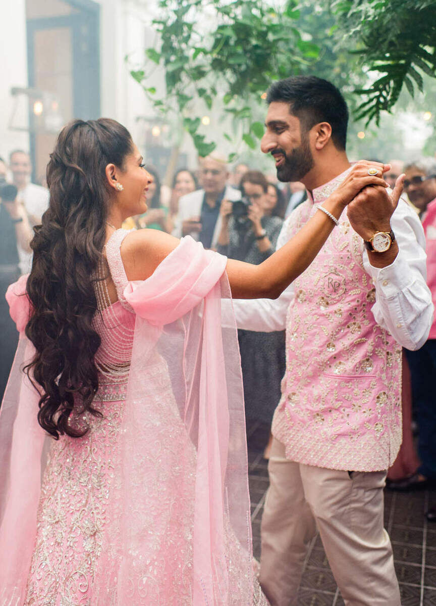 Before their colorful countryside wedding, a bride and groom shared a dance during their henna party in London.