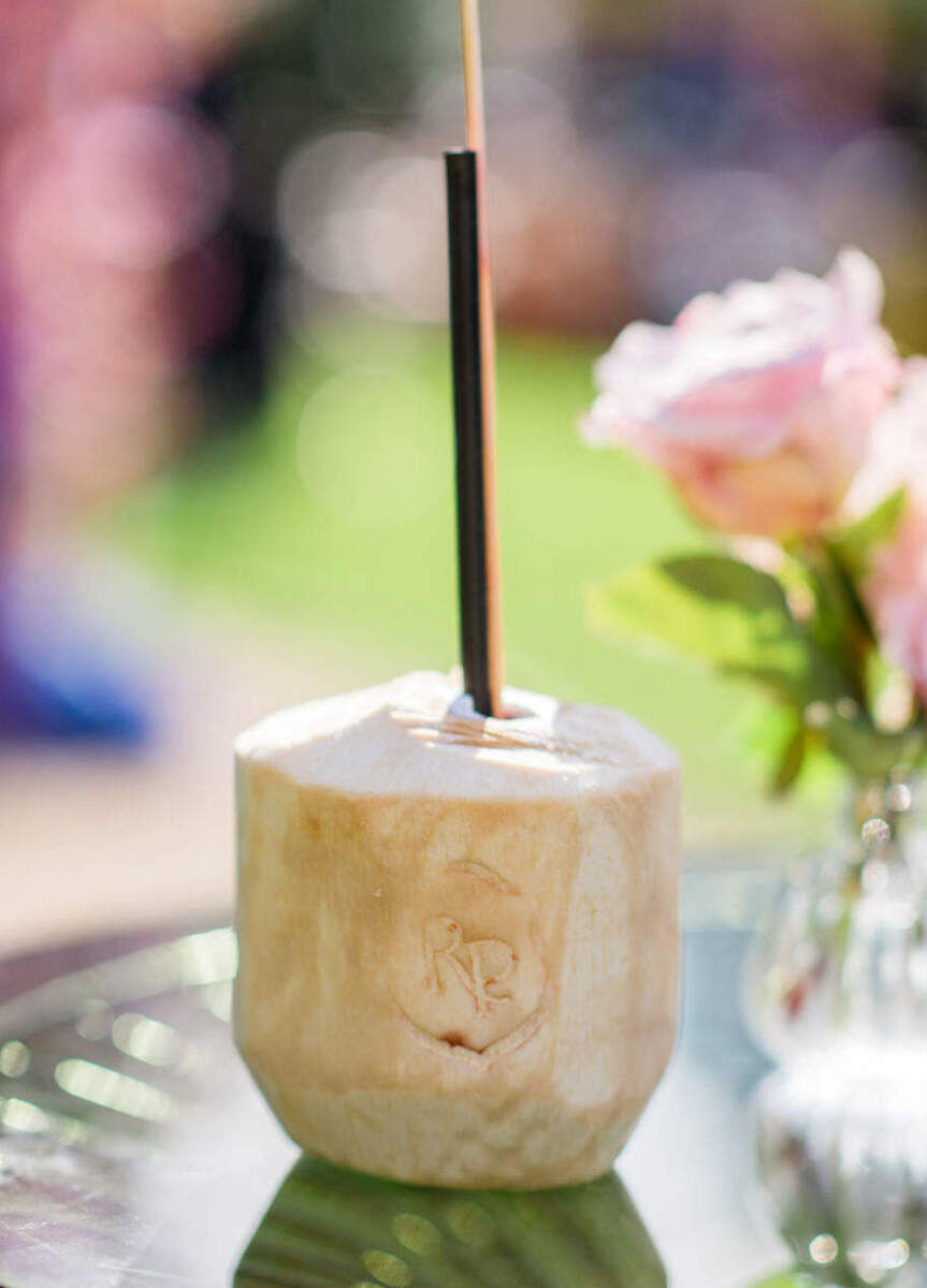 Personalized coconuts fit the beach-inspired vibe of a colorful countryside wedding.
