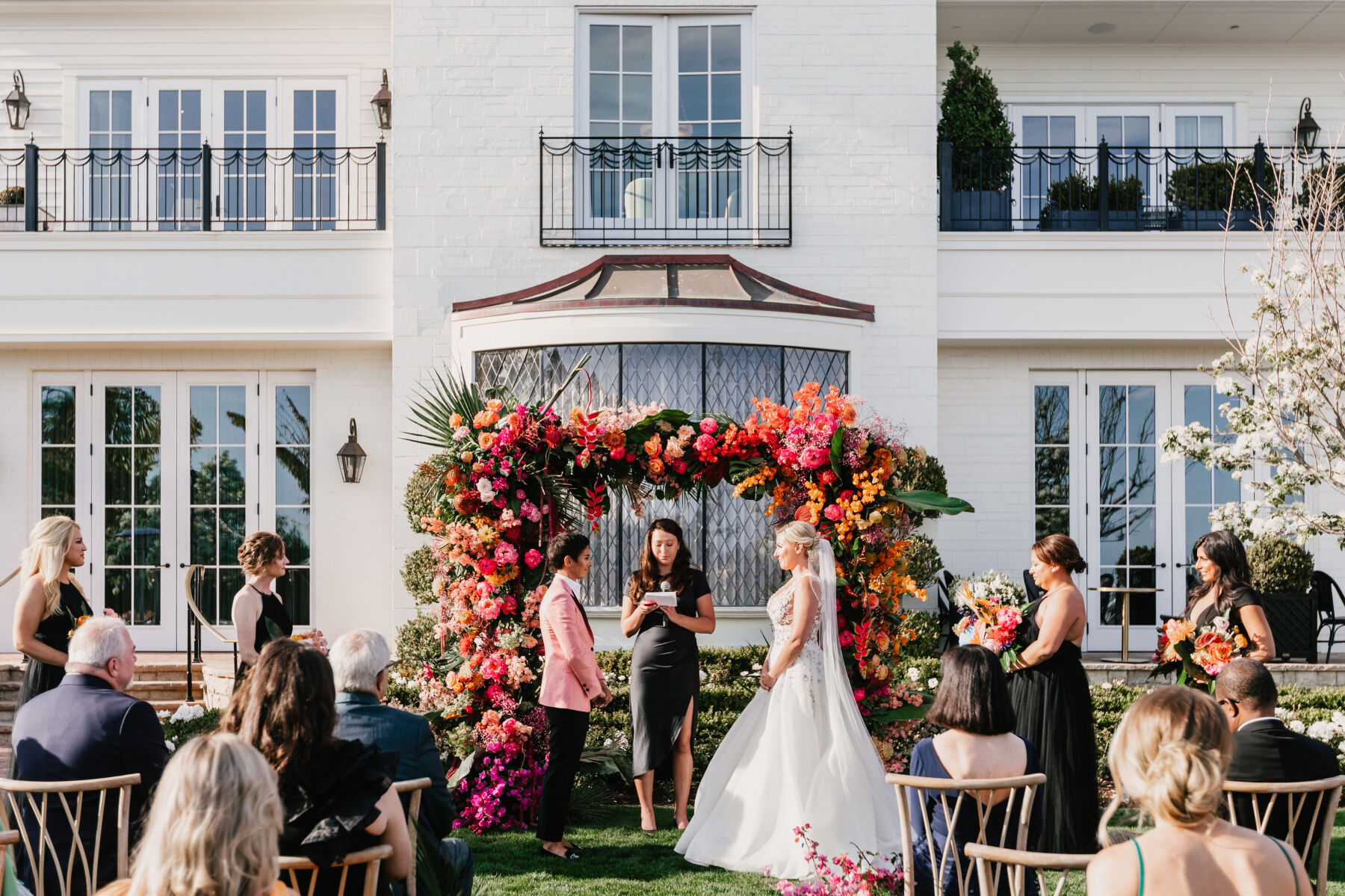 Colorful Wedding: Two brides exchanging vows at Rosewood Miramar Beach, a wedding venue in Montecito, California.